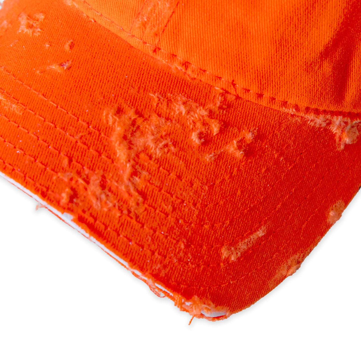 Close-up of an orange fabric surface with texture and wear.