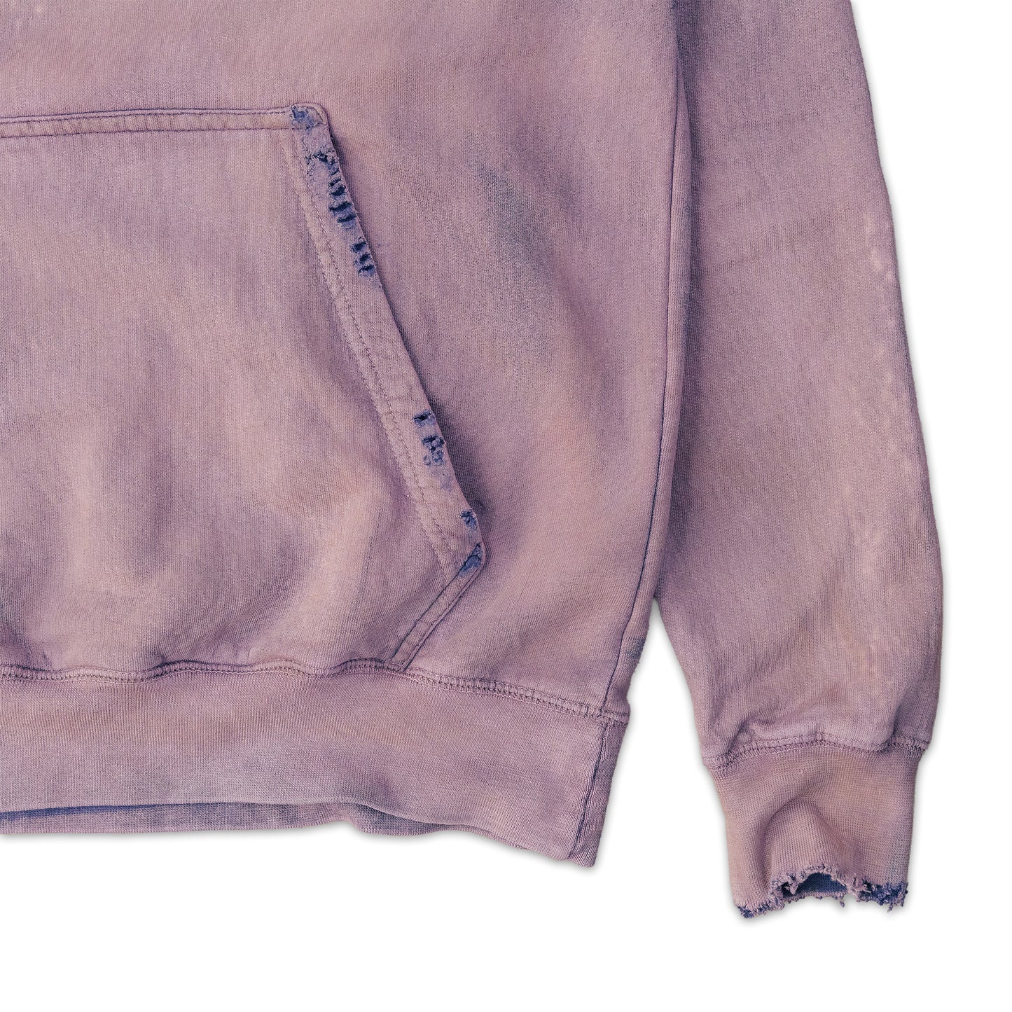 Close-up of a distressed purple sweatshirt with frayed edges on a white background