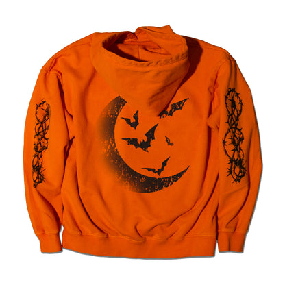 Orange hoodie with crescent moon design featuring a moon, and bats.