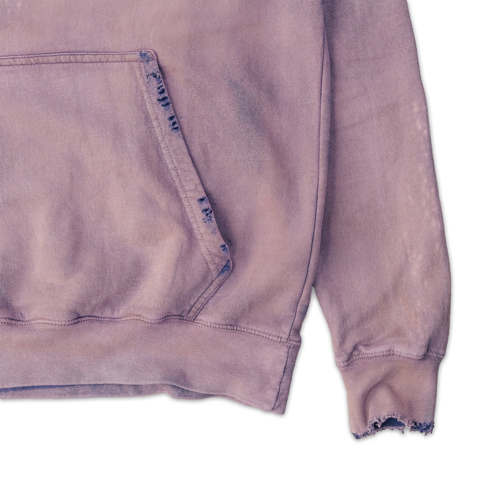 Close-up of a distressed purple sweatshirt with frayed edges on a white background