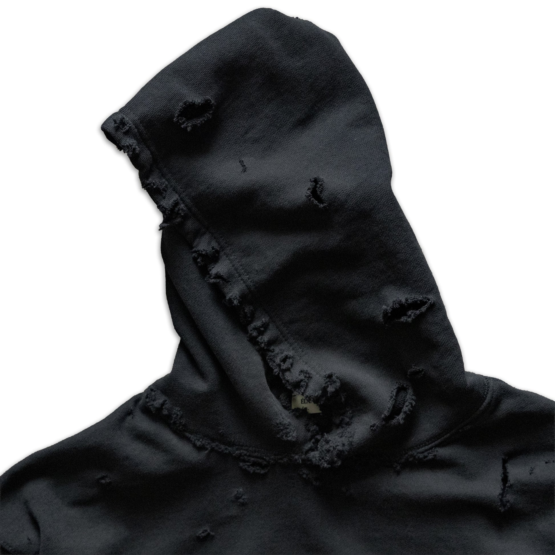 Black hooded garment with frayed edges on a white background