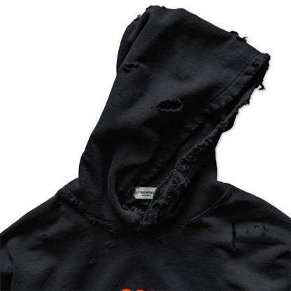 Black distressed hoodie with a visible brand label on a white background