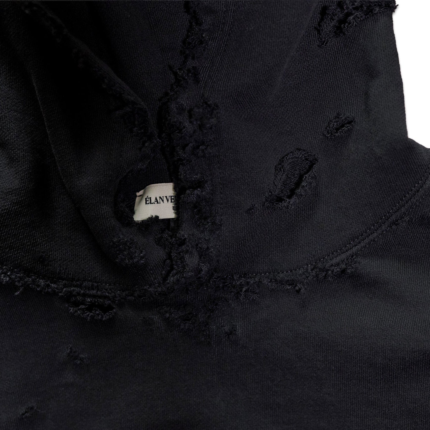 Close-up of a black jacket with a brand label on a white background