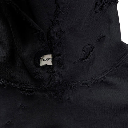 Close-up of a black jacket with a brand label on a white background