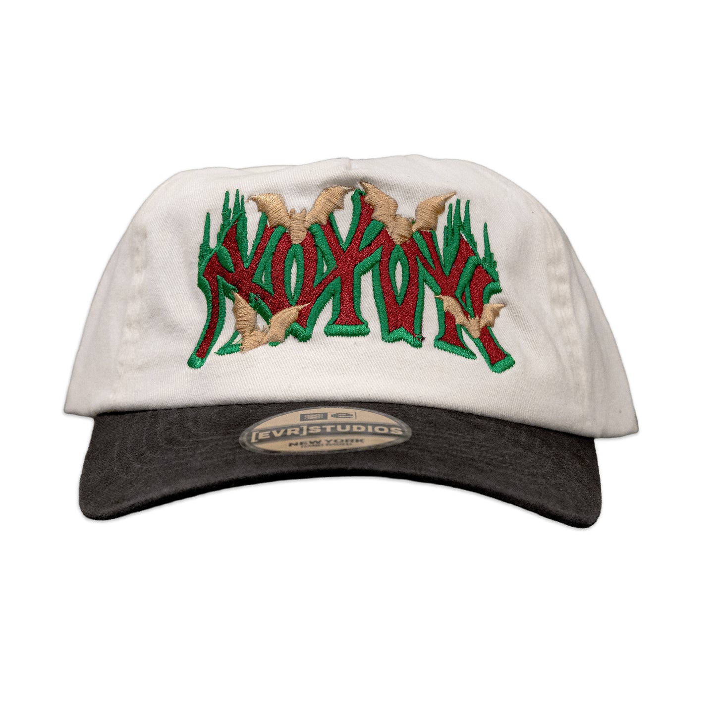 White cap with green and red text and beige accents on a white background