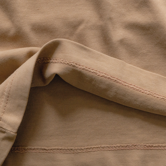 Close-up of beige fabric with visible stitching