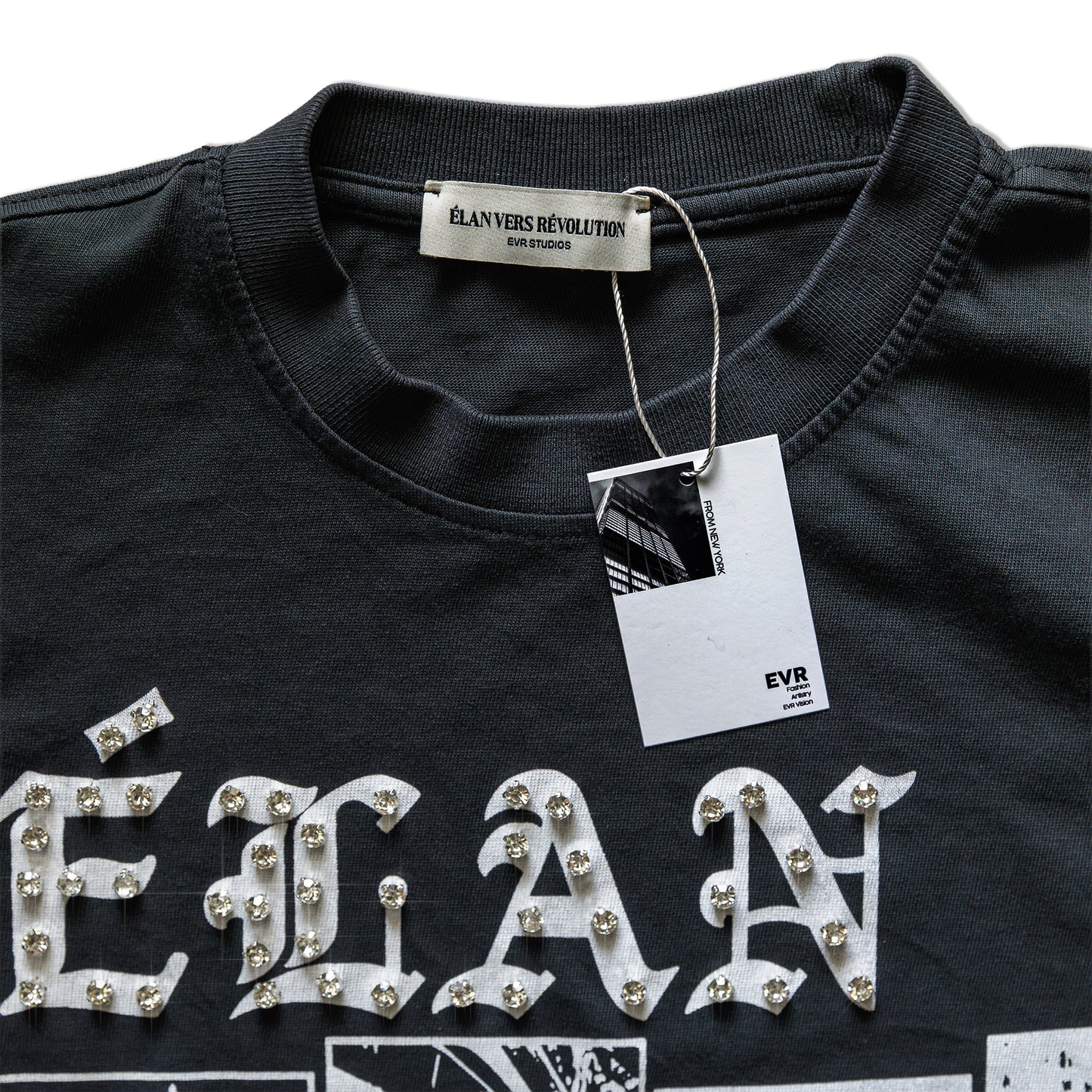 Black shirt with 'élan' text and decorative elements, featuring a brand tag.
