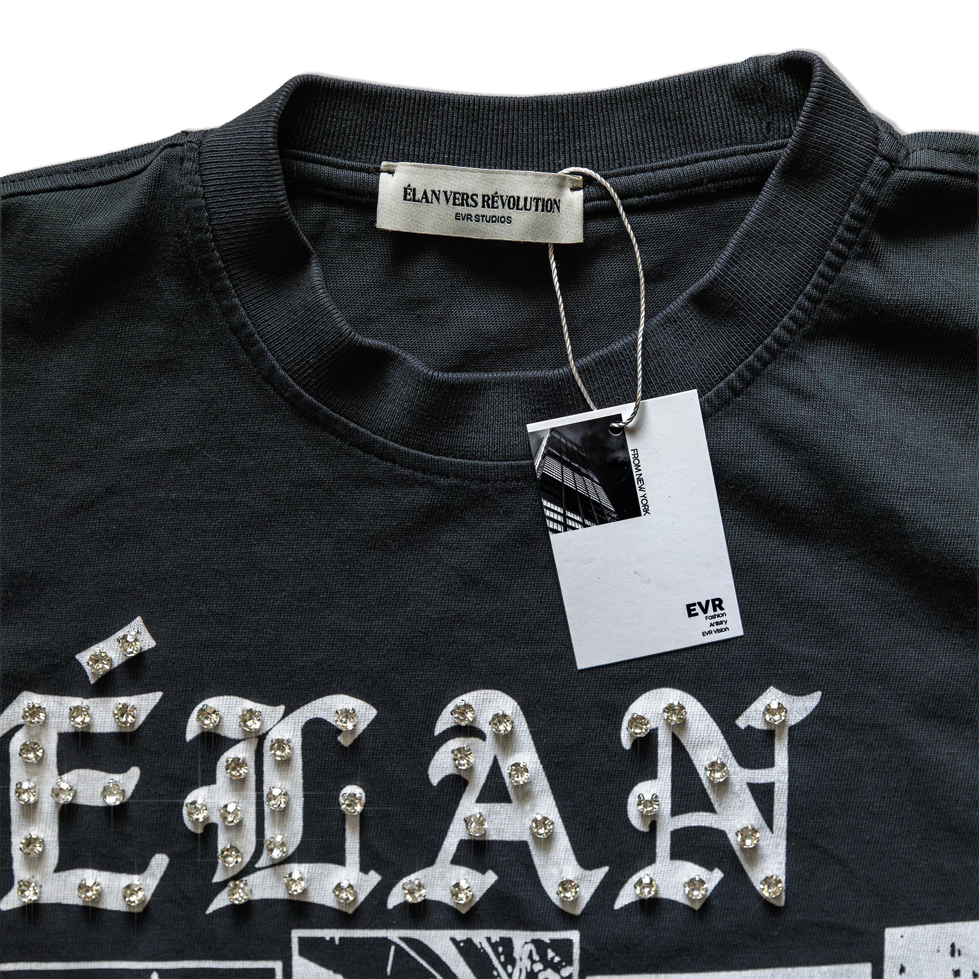 Black shirt with 'élan' text and decorative elements, featuring a brand tag.